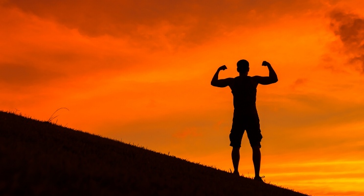 Man posing with his arms at sunset