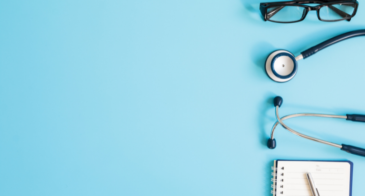 Stethoscope, glasses and notepad