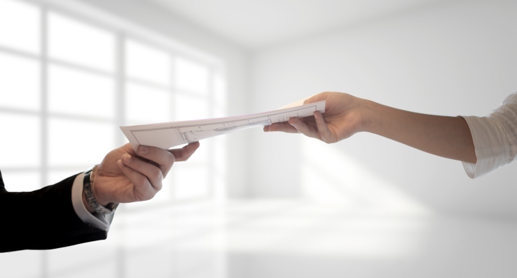 man and woman exchanging paperwork