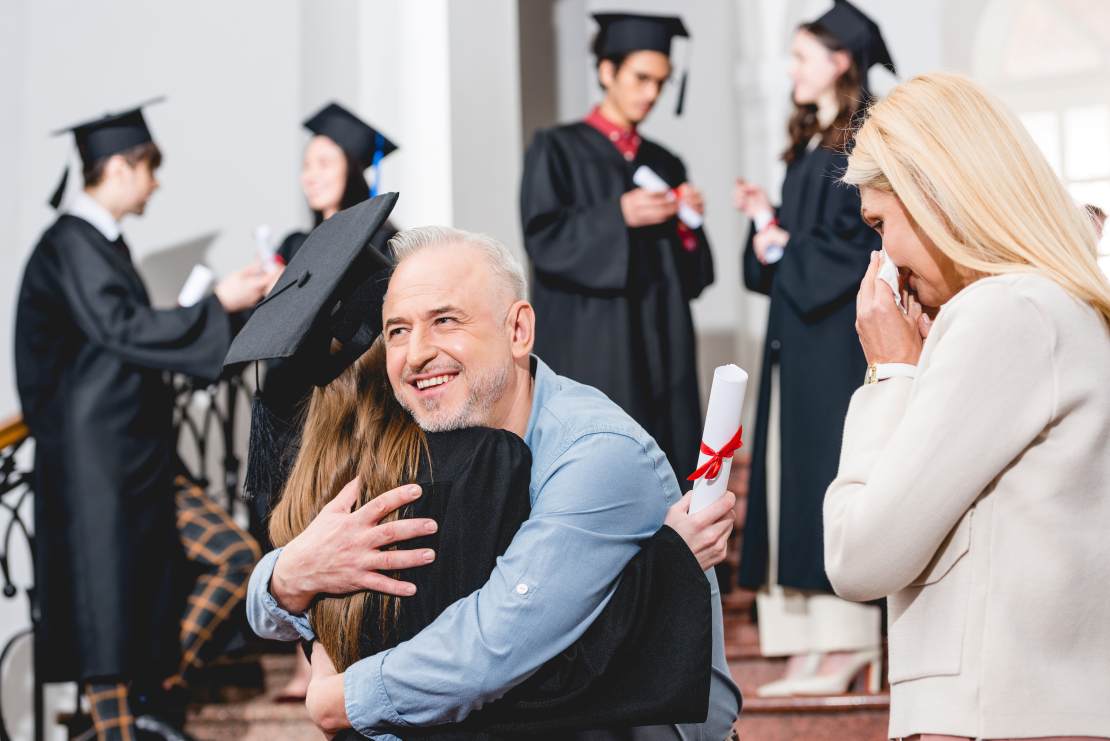 Happy parents or grandparents congratulating their college graduate - did they have to halt retirement savings?