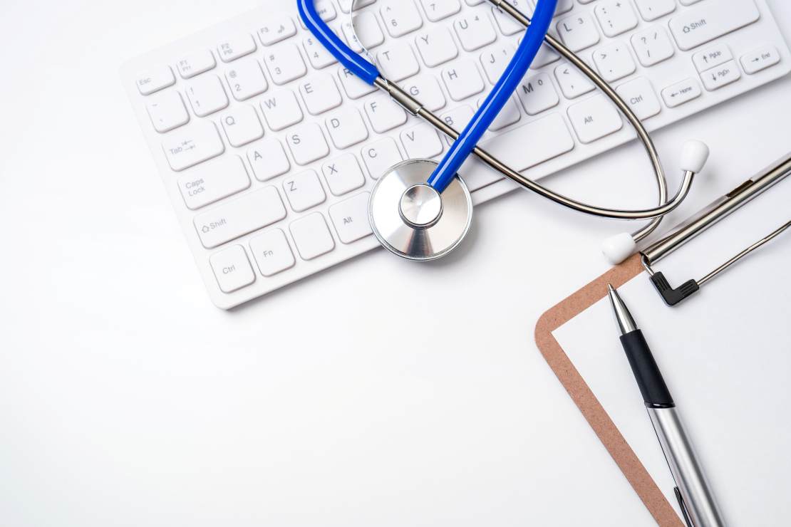 a keyboard, medical chart and stethoscope for a post on thinking about long term care insurance